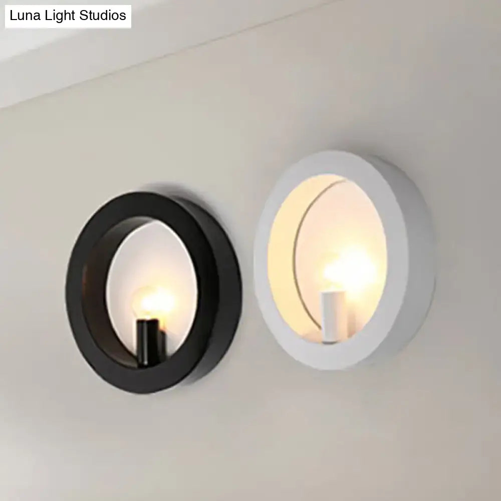 Modern black and white circle wall light featuring a minimalist illuminated bulb design for bedroom wall lamp use