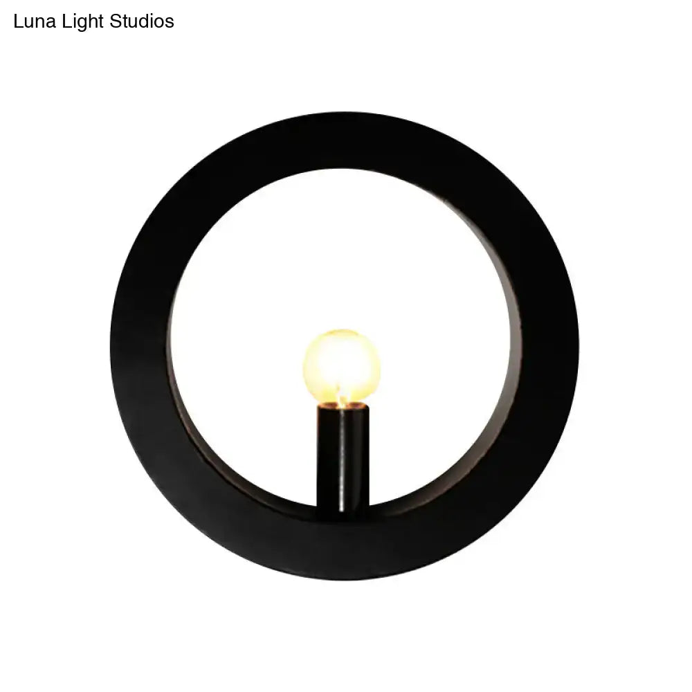 Modern black and white circle wall light features a black circular wall lamp with warm glowing bulb for bedroom use