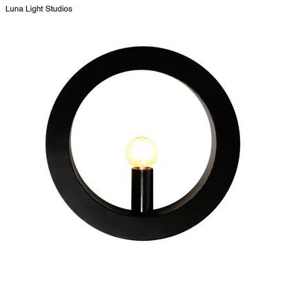 Modern black and white circle wall light features a black circular wall lamp with warm glowing bulb for bedroom use