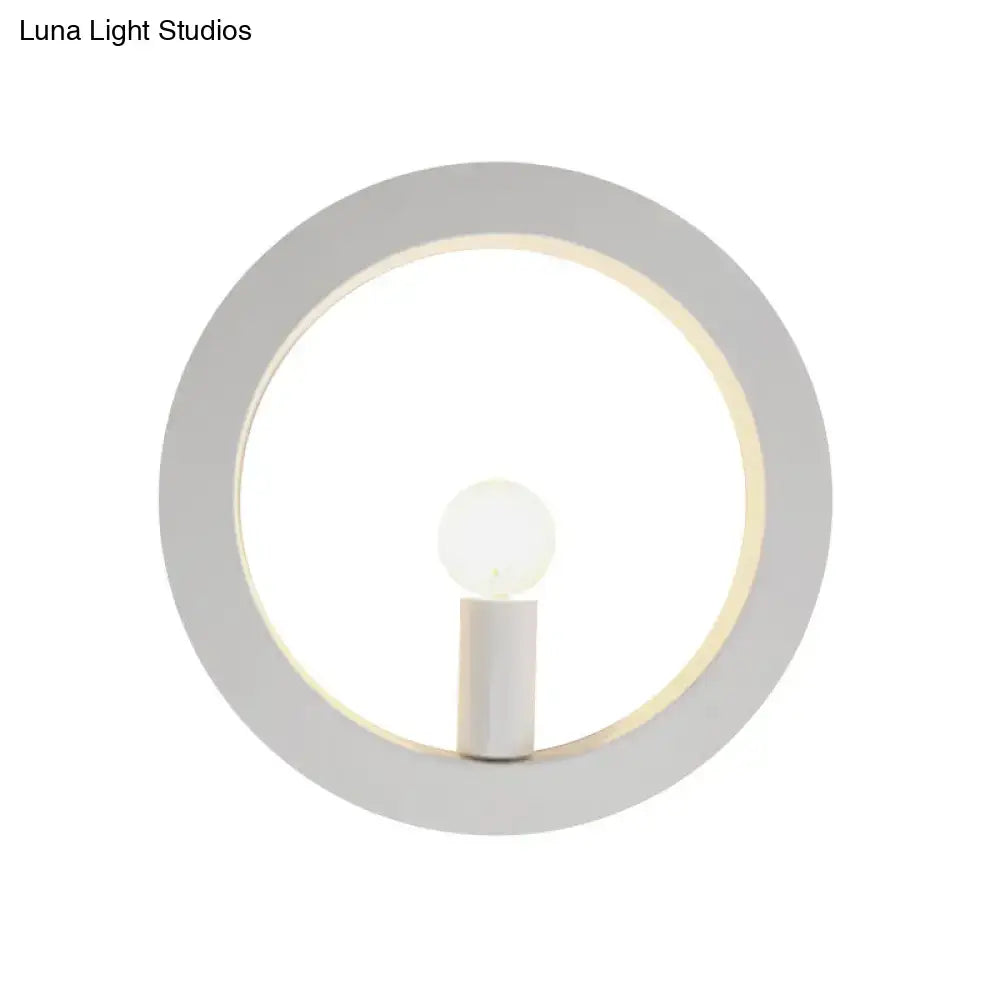 Minimalist modern black and white circle wall light featuring a sleek white frame and illuminated central bulb wall lamp