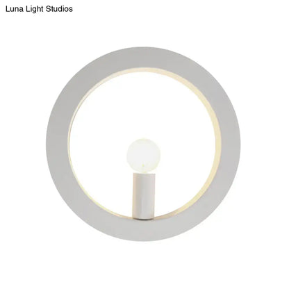 Minimalist modern black and white circle wall light featuring a sleek white frame and illuminated central bulb wall lamp