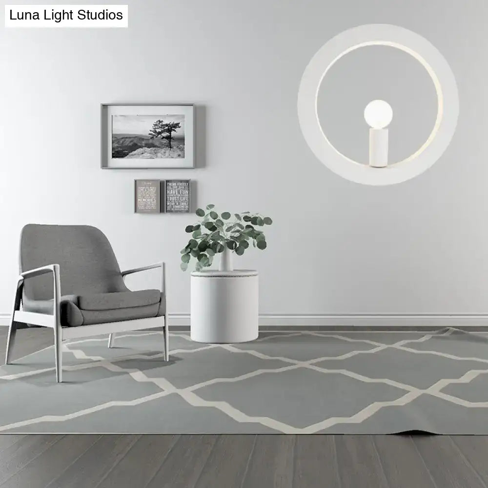 Modern black and white circle wall light featuring a minimalist white circle wall lamp with a glowing ring and central bulb