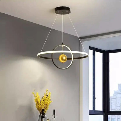 Modern black and white circular iron ball pendant light with matte black rings and a central golden sphere for living room decorbites circular iron