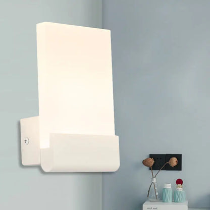 Modern white rectangular led sconce featuring a sleek cuboid design in black and white for bedroom wall lighting