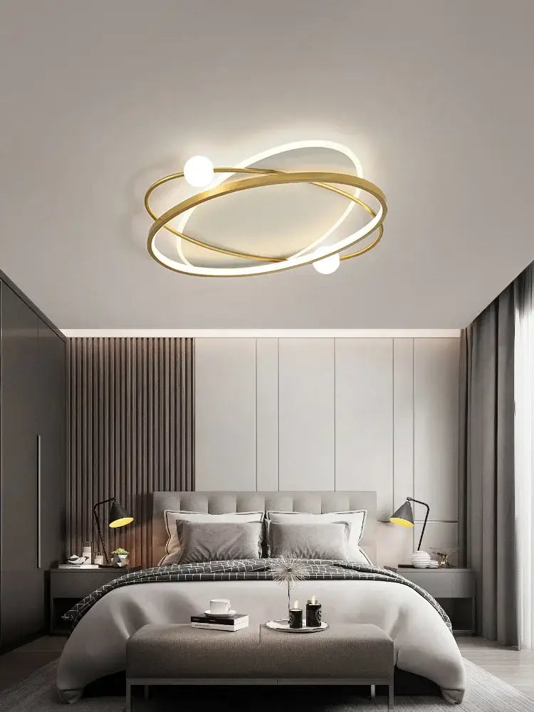 Modern gold-toned decorbites led ceiling light with intertwined rings and spherical bulbs for living room decor