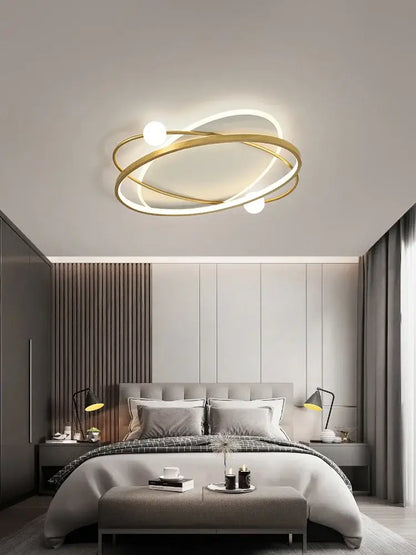 Modern gold-toned decorbites led ceiling light with intertwined rings and spherical bulbs for living room decor