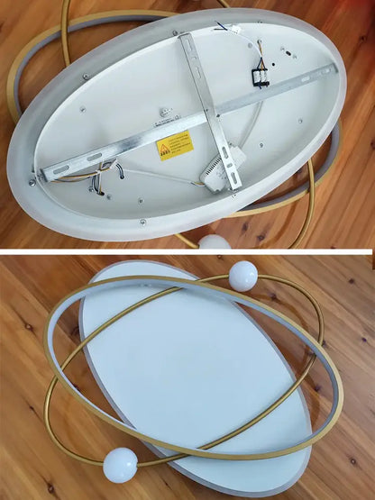 Modern black and white decorbites led ceiling light with white matte finish, gold rings, and spherical bulbs for living room
