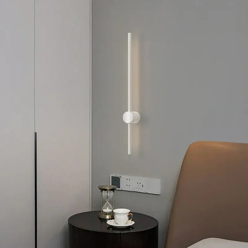 Minimalist white decorbites dimmable led wall sconce with sleek vertical bar and circular base for modern bedroom wall lights