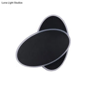 Modern black double oval wall sconce lamp with silver metallic trim for bedside bedroom lighting