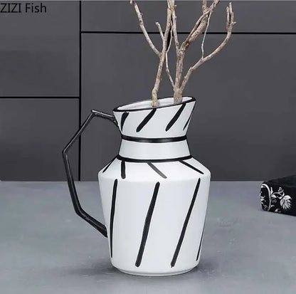 White ceramic elegant striped ceramic pitcher with black geometric stripes and hexagonal handle holding dried branches for decorbites elegant striped decor