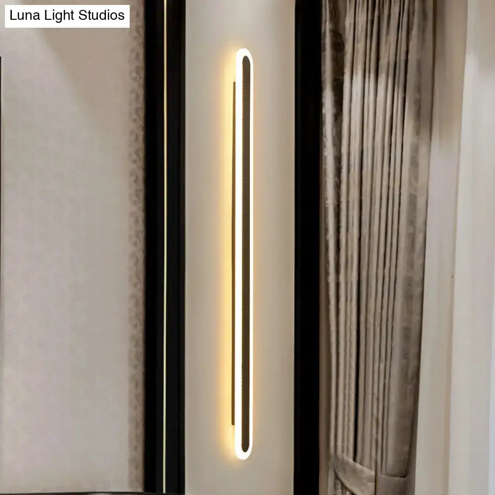 Modern black and white elliptical acrylic wall sconce with sleek rectangular design and warm white led lighting flush mounted