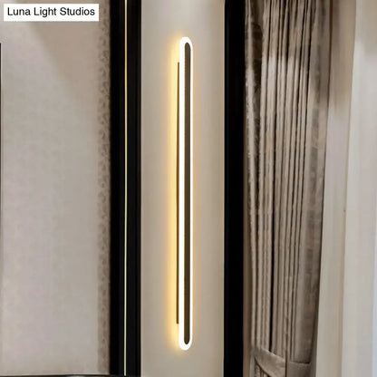 Modern black and white elliptical acrylic wall sconce with sleek rectangular design and warm white led lighting flush mounted
