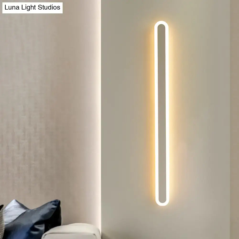 Modern black and white elliptical acrylic wall sconce with sleek minimalist design and warm white led illumination