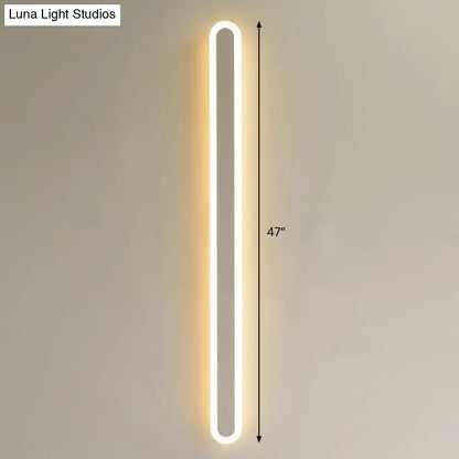 Modern black and white elliptical acrylic wall sconce with warm white illumination and sleek elliptical acrylic flush design