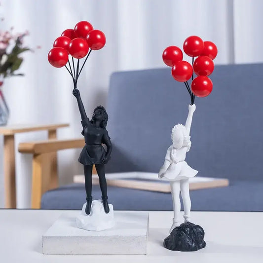 Two resin love balloon girl sculptures one black and one white holding red balloons modern decorbites flying love