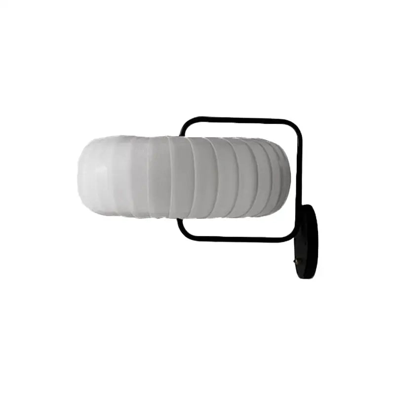 Modern black and white gathered fabric pumpkin wall sconce with frosted ribbed glass shade and sleek metal frame for bedroom lighting