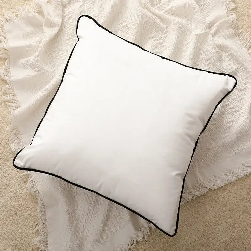 White square cushion cover with black stitched border featuring modern geometric embroidered design for living room