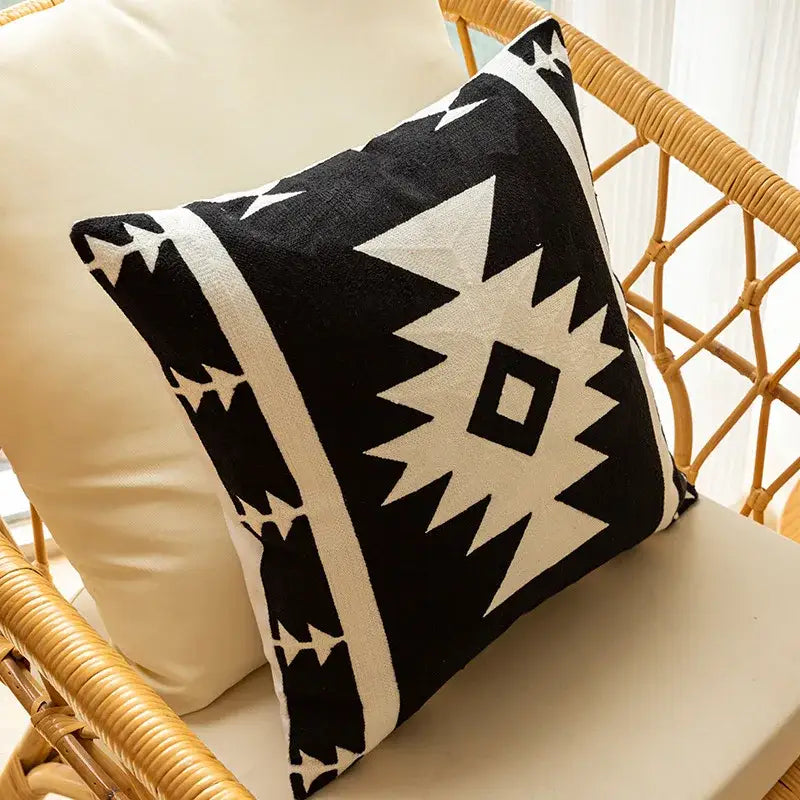 Modern black and white geometric embroidered cushion cover with bold tribal-inspired design for living room decor