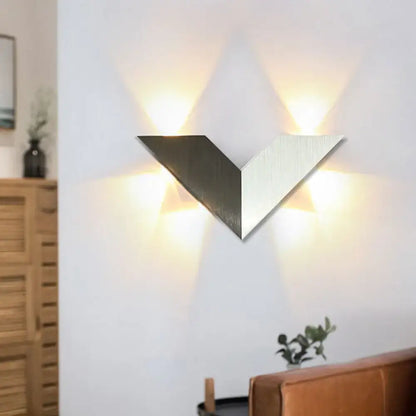 Modern led black and white wall lamp with geometric metal shade and brushed metallic v-shaped sconce with three warm lights