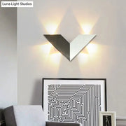 Modern black and white geometric metal shade led wall lamp with v-shaped two-tone metallic panels for bedroom use
