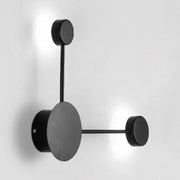 Modern black minimalist wall sconce with circular geometric design and matte finish light fixture for living room