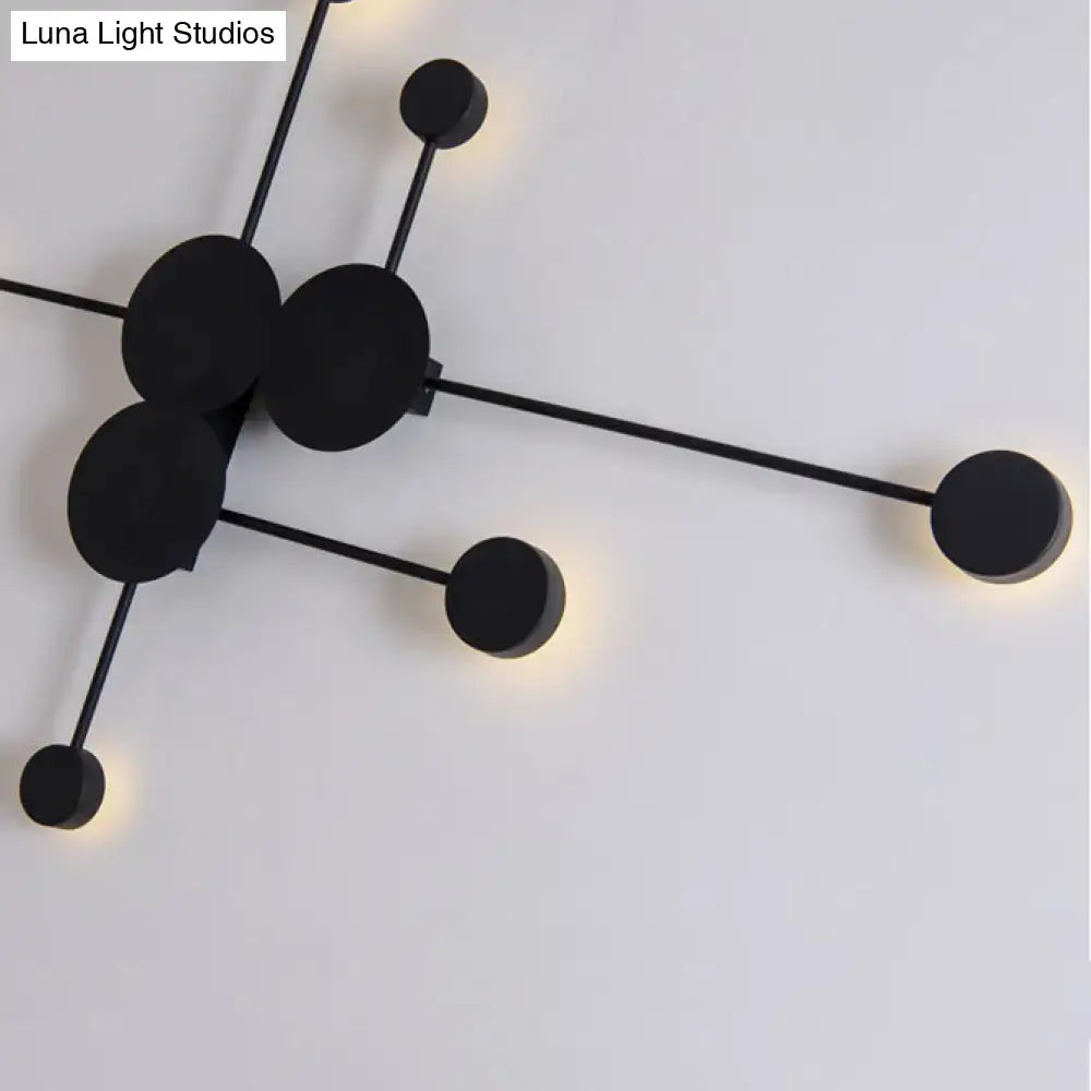 Modern black wall sconce with minimalist rods and circular fixtures serving as a geometric living room light fixture