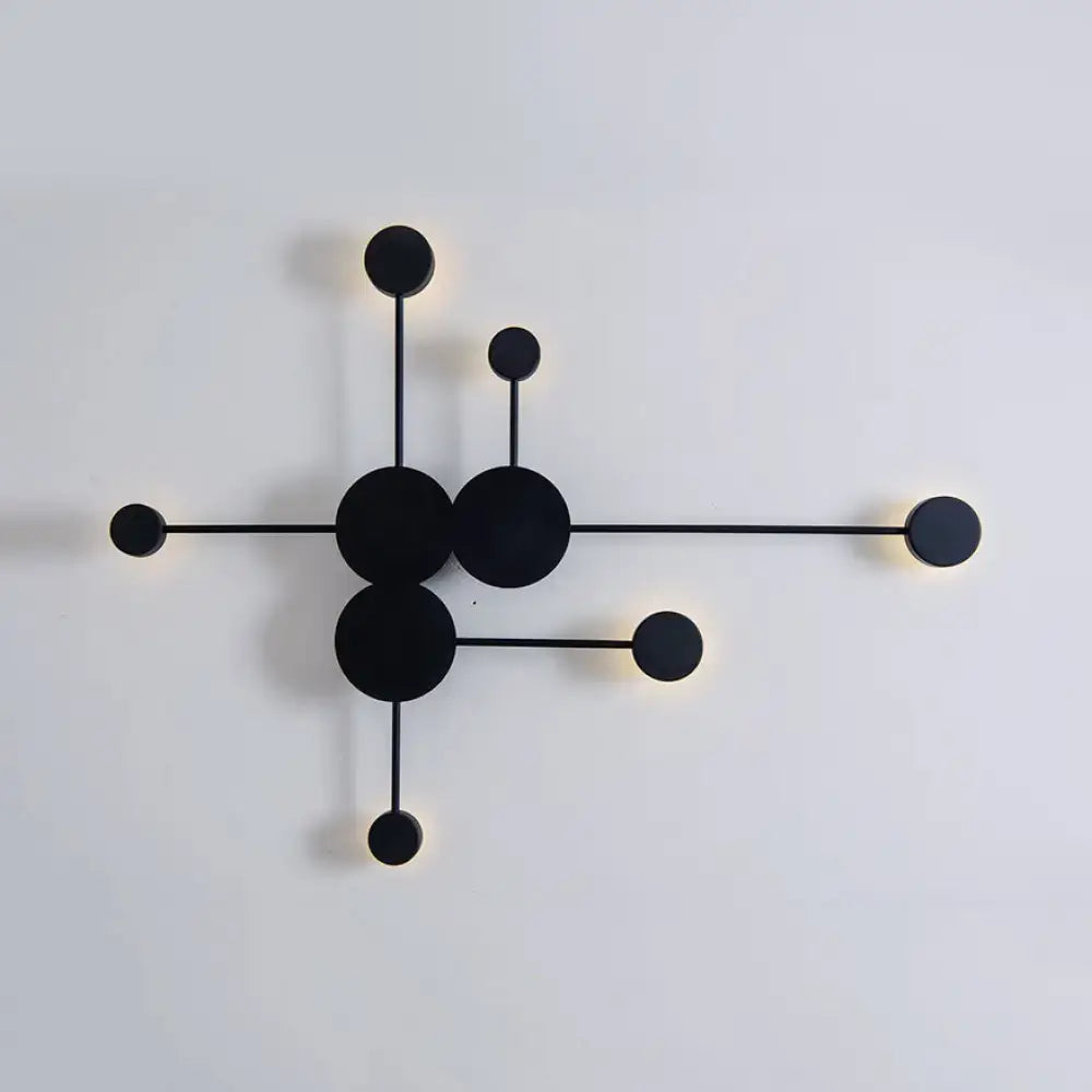 Modern black wall sconce light fixture with minimalist geometric design featuring interconnected circles and rods