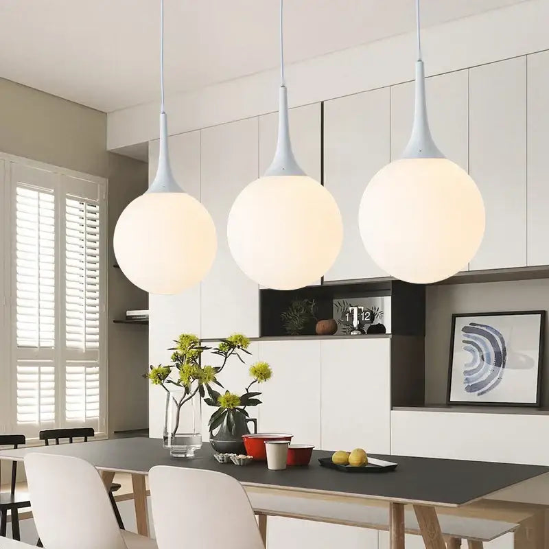 Three modern pendant lights with matte white teardrop fixtures and frosted glass globes by decorbites glass ball led design