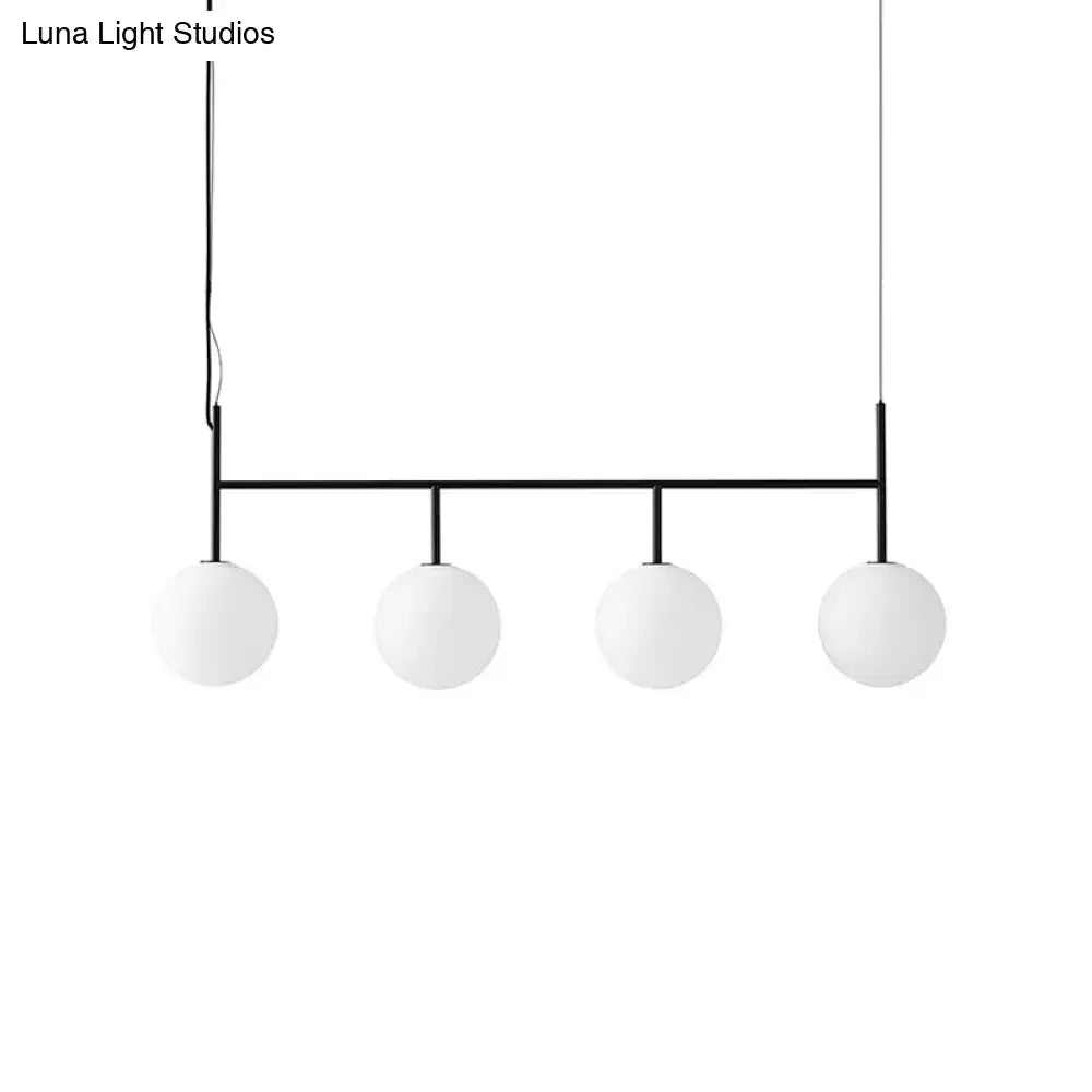 DecorBites contemporary black suspended island light fixture with minimalist metal frame and four white glass orb pendants