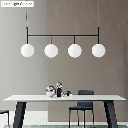Decorbites contemporary black metal pendant light with four frosted white glass orb globes for island lighting