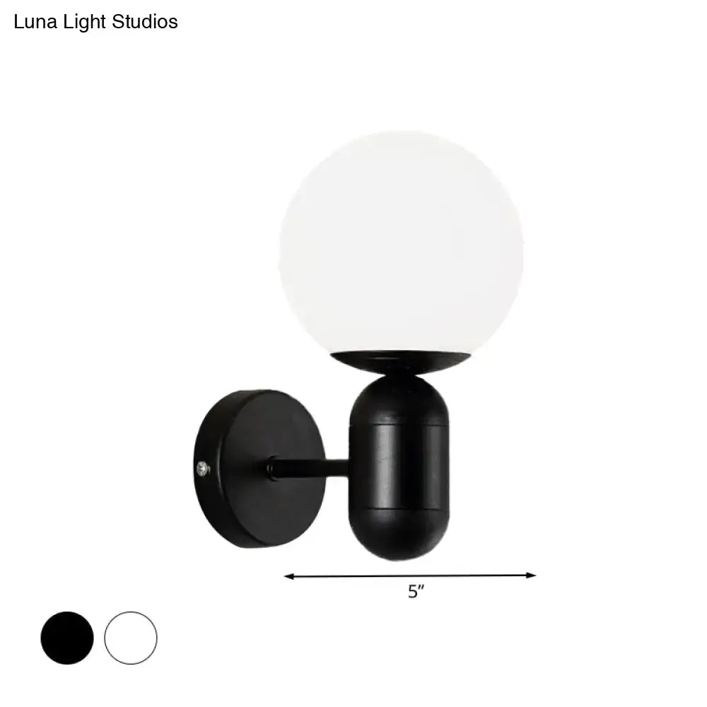 Modern black and white glass wall light featuring a minimalist black spherical globe wall lamp for meeting rooms