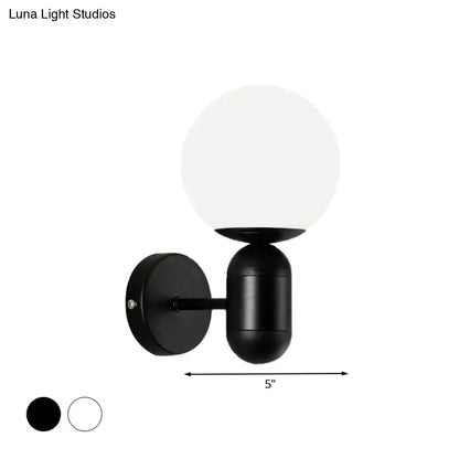 Modern black and white glass wall light featuring a minimalist black spherical globe wall lamp for meeting rooms