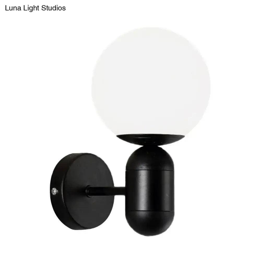 Modern black spherical wall lamp with frosted glass globe designed as a glass wall light for meeting rooms