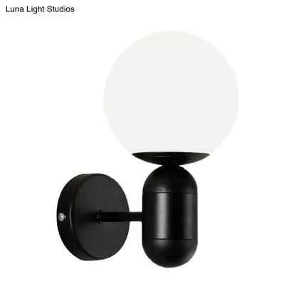 Modern black spherical wall lamp with frosted glass globe designed as a glass wall light for meeting rooms