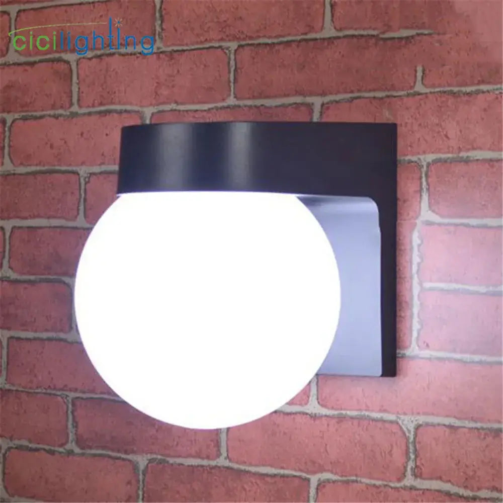 Modern black wall lamp with spherical frosted glass globe and matte metal bracket for outdoor porch light use