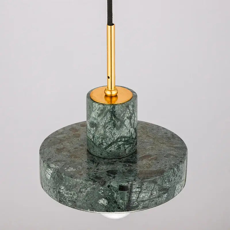Modern black and white green marble pendant light with gold-toned metal stem and circular base for dining room decorbites green marble