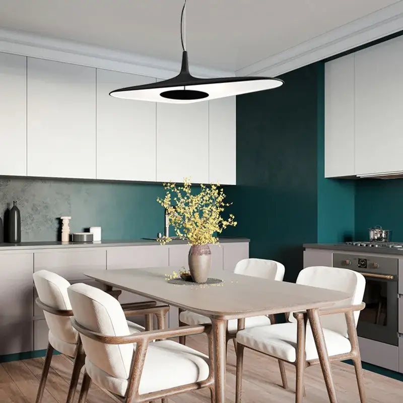 Modern black and white irregular resin pendant light with sleek disc-shaped design hanging above dining table decorbites irregular resin pendant