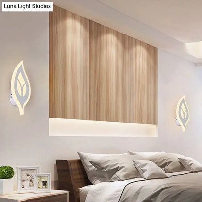 Modern black and white leaf sconce light with minimalist design and soft ambient lighting as a bedroom wall lamp
