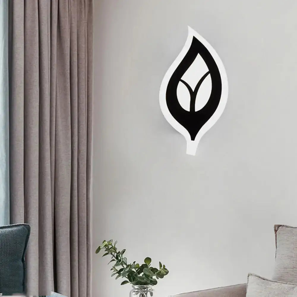 Modern black and white leaf sconce light with minimalist wall lamp design for bedroom decor