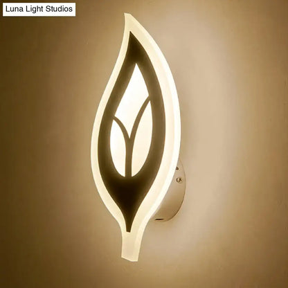 Modern black white leaf sconce light wall lamp with sleek design and warm illuminated inner silhouette for bedroom