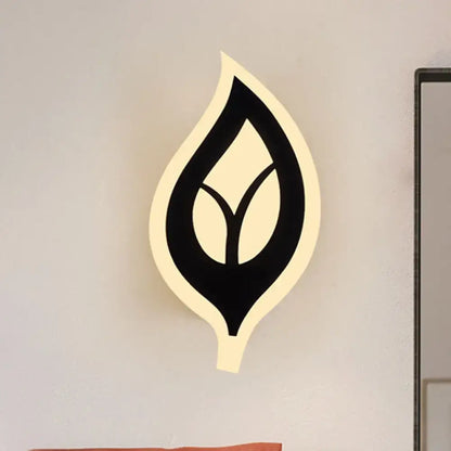 Modern black white leaf sconce light with sleek design and warm illuminated outline for bedroom wall lamp use