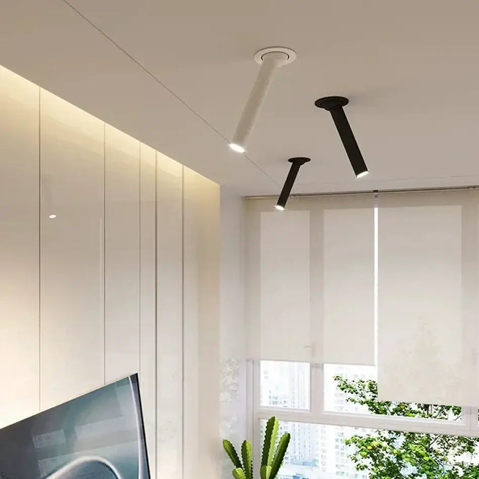 Two modern minimalist black and white led bar ceiling spotlights with sleek cylindrical bodies for kitchen lighting