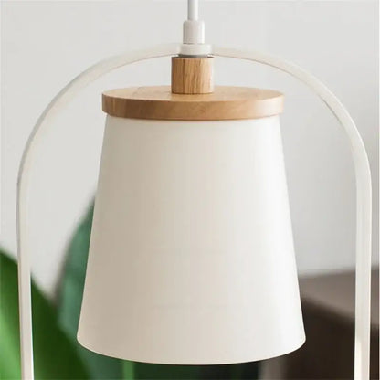 A minimalist white pendant lamp with wooden top and curved metal frame featured alongside decorbites led bird wall sconce