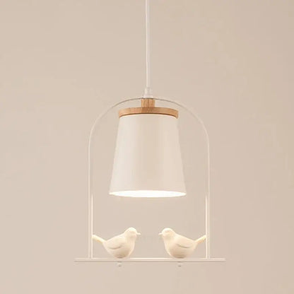 Modern black and white led bird wall sconce featuring a white ceramic bird pendant with minimalist metal frame and wooden accent decorbites led bird