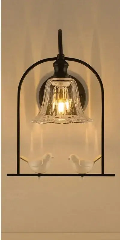 Modern black metal led bird wall sconce with clear glass shade and white ceramic birds by decorbites led bird decor