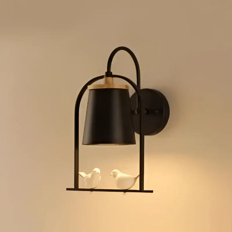 Modern black metal led bird wall sconce with warm light and two white ceramic birds under a bell-shaped shade decorbites led bird