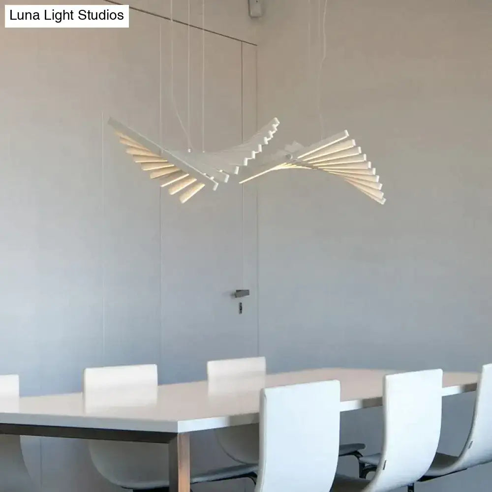 DecorBites™ modern led chandelier featuring a sleek white bird-shaped pendant with layered wing panels above dining table