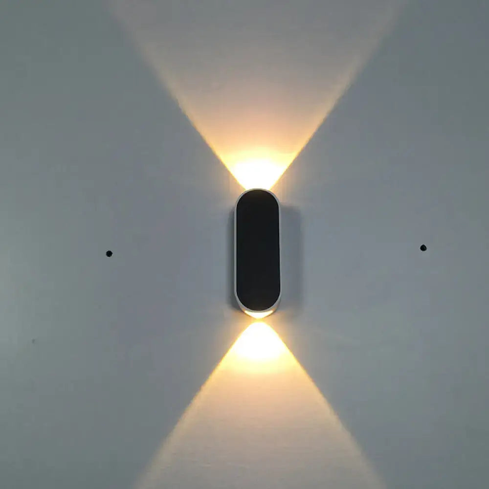 Modern black wall lamp with metal shade and led flush wall design projecting two warm light beams for bedroom use