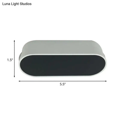 Modern oval-shaped led flush wall lamp with metal shade in matte gray and black by Luna Light Studios for bedroom use