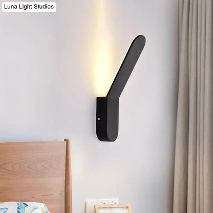 Modern black and white oval shape corridor wall sconce with sleek angular design and warm led lighting
